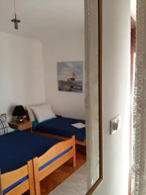 a bedroom with a bed and a mirror at Lazar Apartments in Petrovac na Moru