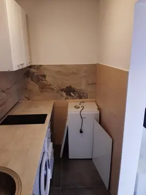 a small kitchen with a counter and a sink at Apartments Mušović in Bar