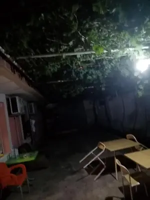 a dark room with tables and chairs at night at Apartments Mušović in Bar