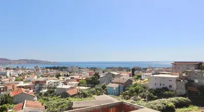 a view of a city with the ocean in the background at Apartments Mušović in Bar