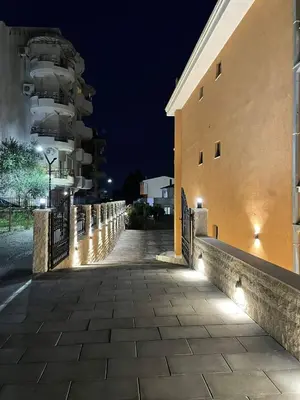 a walkway next to a building at night at Apartments Zati in Ulcinj