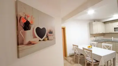 a kitchen and dining room with a white table and chairs at Apartment Nia in Budva