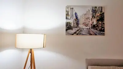 a lamp next to a wall with a painting on it at Apartment Nia in Budva