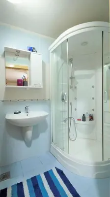a white bathroom with a sink and a shower at Apartment Nia in Budva