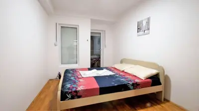a small bedroom with a bed in a room at Apartment Nia in Budva
