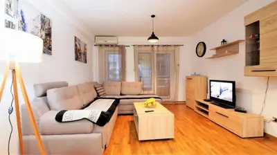 a living room with a couch and a tv at Apartment Nia in Budva