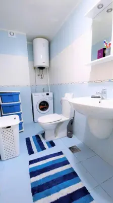 a blue and white bathroom with a sink and a toilet at Apartment Nia in Budva