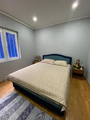 a bedroom with a bed with a blue headboard at Skadar Lake Apartment -Karolina in Vranjina