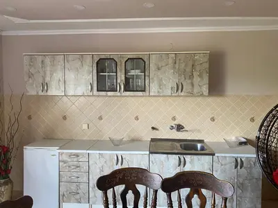 a kitchen with two chairs in front of a sink at Skadar Lake Apartment -Karolina in Vranjina