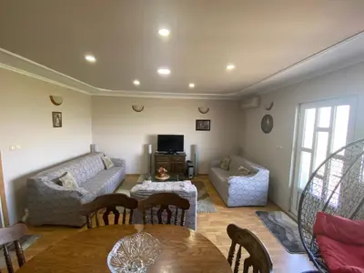 a living room with a couch and a table and chairs at Skadar Lake Apartment -Karolina in Vranjina