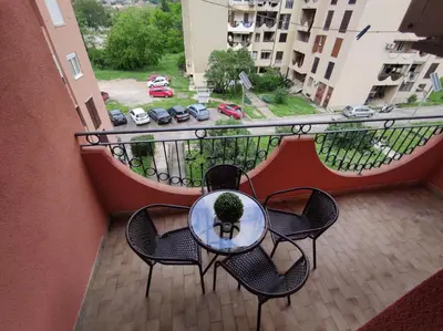a table and chairs on a balcony with a view at Apartment City View in Kotor