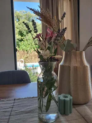 a vase with flowers in it sitting on a table at Once Upon a Time in Montenegro in Sutomore
