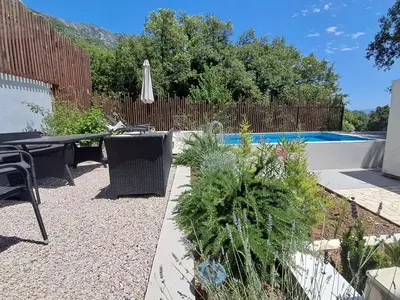 a patio with a table and chairs and a pool at Once Upon a Time in Montenegro in Sutomore