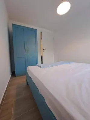 a bedroom with a bed and a blue cabinet at Once Upon a Time in Montenegro in Sutomore