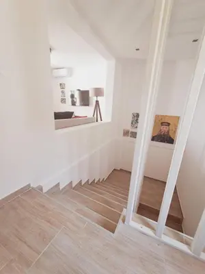 a staircase with white walls and wooden flooring at Once Upon a Time in Montenegro in Sutomore