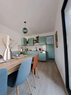 a kitchen with a wooden table and blue chairs at Once Upon a Time in Montenegro in Sutomore