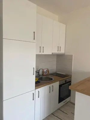 a kitchen with white cabinets and a sink at Jelena apartment Bar in Bar