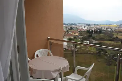 a balcony with a table and chairs and a view at Jelena apartment Bar in Bar