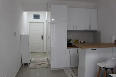 a kitchen with white cabinets and a white refrigerator at Jelena apartment Bar in Bar
