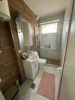 a bathroom with a sink and a toilet and a window at Moderan Studio na Trgu Republike - Centar in Podgorica