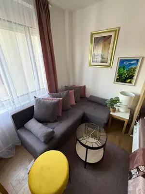 a living room with a couch and a table at Moderan Studio na Trgu Republike - Centar in Podgorica