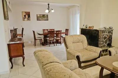 a living room with a couch and chairs and a table at Apartments Klara in Utjeha