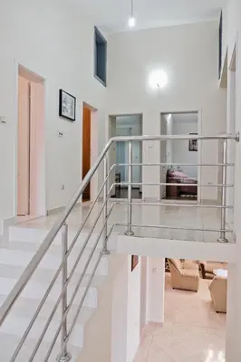 a staircase in a house with white walls at Apartments Klara in Utjeha