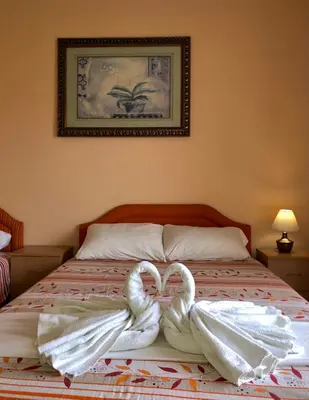 two swans towels are sitting on a bed at Apartments Ela in Ulcinj