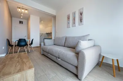 a living room with a couch and a table at Niki Apartments Pržno in Sveti Stefan