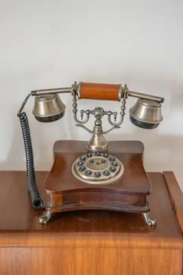 an old fashioned telephone sitting on a wooden table at S&P City Center Apartments in Kotor
