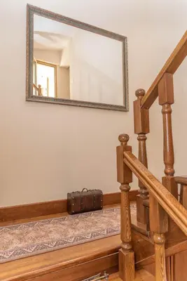 a mirror on the wall above a staircase with a suitcase at S&P City Center Apartments in Kotor