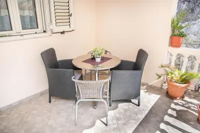 a small table and chairs in a room at S&P City Center Apartments in Kotor