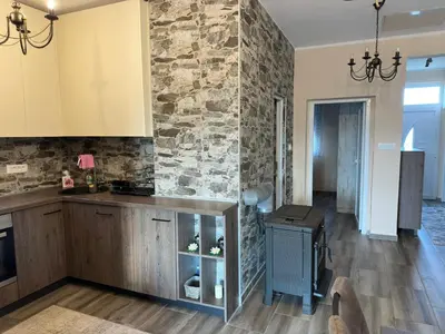 a kitchen with a stone wall and a counter at Casa di Kiara, Skadar Lake in Dodoši