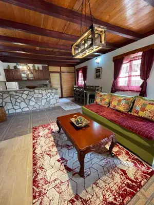 a living room with a couch and a table at Casa di Kiara, Skadar Lake in Dodoši