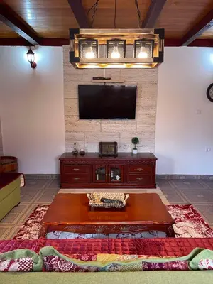 a living room with a flat screen tv on a wall at Casa di Kiara, Skadar Lake in Dodoši