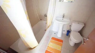 a bathroom with a sink and a toilet and a shower at Petrovac Bay Apartments in Petrovac na Moru