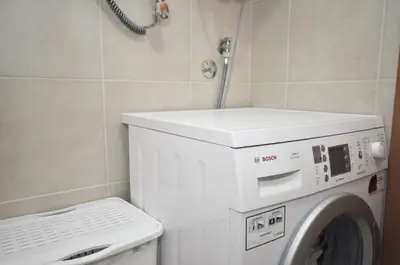 a washing machine in a bathroom with a washer at Petrovac Bay Apartments in Petrovac na Moru