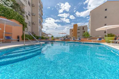 a large blue swimming pool in a building at Petrovac Bay Apartments in Petrovac na Moru