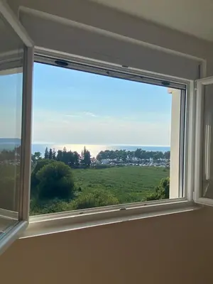 a window with a view of a green field at Ačanski Apartments Bar in Bar