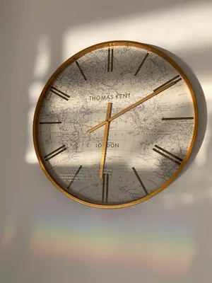 a clock with a map on a wall at Ačanski Apartments Bar in Bar