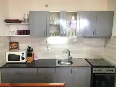 a kitchen with a sink and a microwave at Ačanski Apartments Bar in Bar