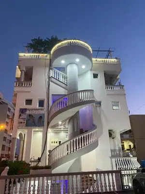 a building with balconies on the side of it at Apartments Delfin in Ulcinj