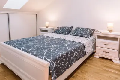 a bedroom with a large bed and two night stands at MT One-bedroom boho apartment, Budva in Budva
