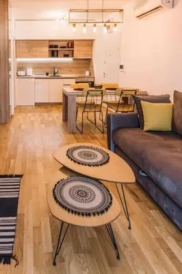 a living room with a couch and a table at MT One-bedroom boho apartment, Budva in Budva