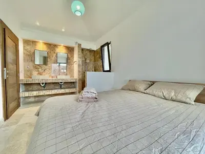 a large bedroom with a large bed and a bathroom at Family Vacation Villa Rezevici in Budva