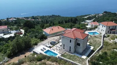 an aerial view of a house with two swimming pools at Family Vacation Villa Rezevici in Budva