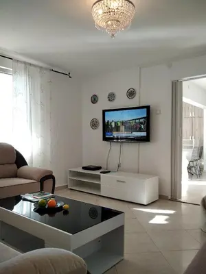 a living room with a flat screen tv on the wall at ApartToni in Dobra Voda