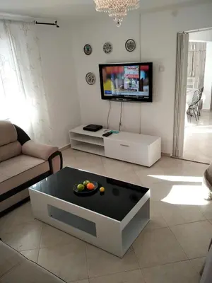 a living room with a tv and a coffee table at ApartToni in Dobra Voda
