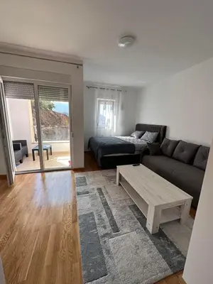 a living room with a couch and a coffee table at Lux studio apartment Bečići-Budva in Budva