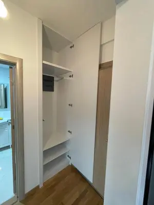 a walk in closet with a door in a room at Lux studio apartment Bečići-Budva in Budva
